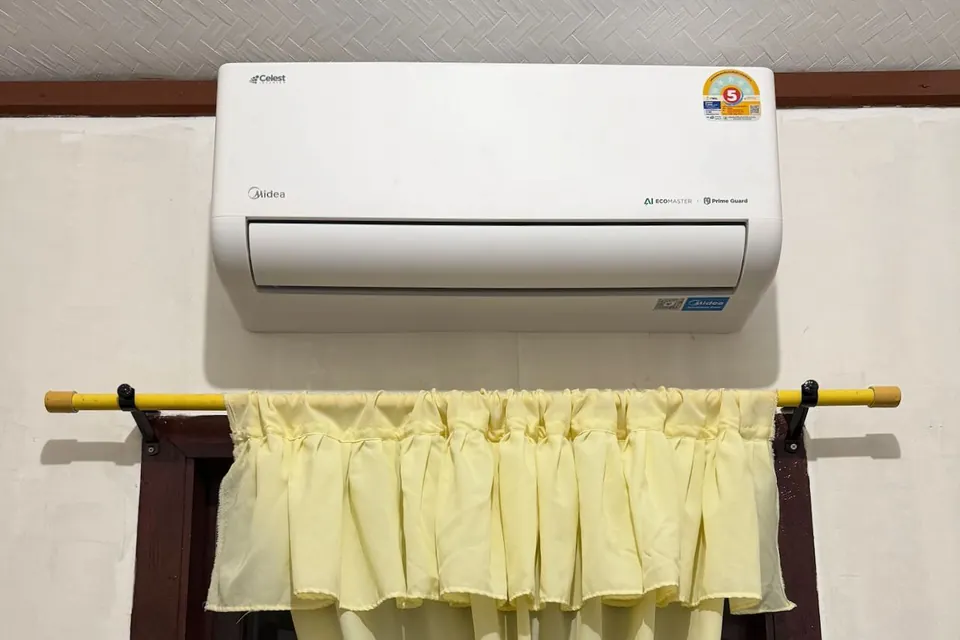 The room's air-conditioning unit, mounted on the wall above the window